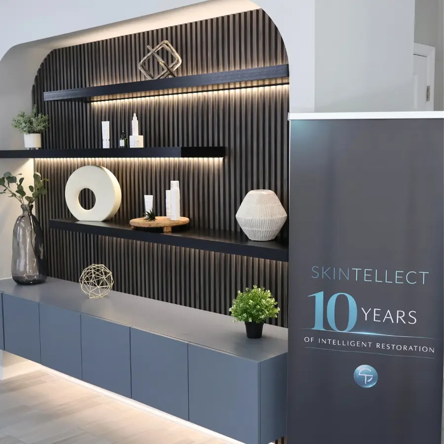 Skintellect Laser & Aesthetics lobby showcasing 10-year anniversary, featuring a clean modern reception area with branded decor highlighting the milestone.